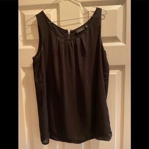 Black sleeveless blouse with gold zipper on back.